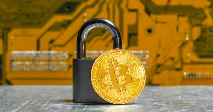 Gold bitcoin and padlock