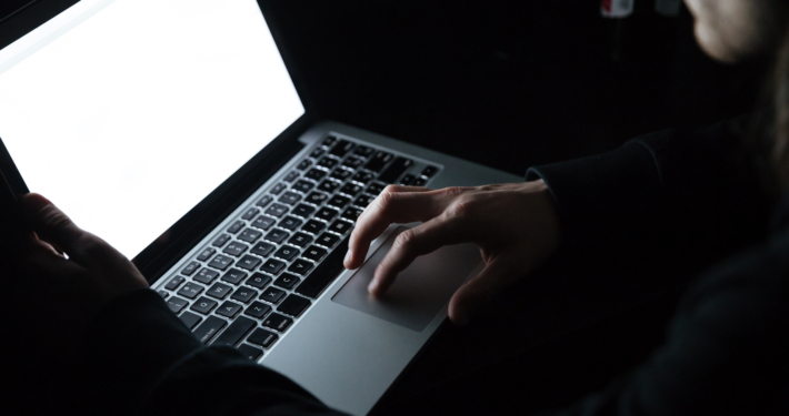 Concentrated man using laptop computer at home